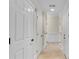 Hallway featuring neutral colored walls, a tiled floor, and white doors with contrasting black hardware at 1029 Fairway Ne Ests, Atlanta, GA 30319