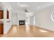 Bright living room features a fireplace, hardwood floors, and modern ceiling fan at 1029 Fairway Ne Ests, Atlanta, GA 30319