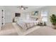 Bright main bedroom featuring a ceiling fan, TV, and a mirrored dresser and nightstand at 1029 Fairway Ne Ests, Atlanta, GA 30319