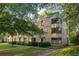 Attractive brick apartment building with lush green landscaping, mature trees, and manicured bushes at 1190 Briarcliff Ne Rd # 1, Atlanta, GA 30306