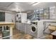 Spacious laundry room with multiple washers and dryers and abundant natural light from the large window at 1190 Briarcliff Ne Rd # 1, Atlanta, GA 30306