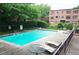 Community pool surrounded by lounge chairs and well-maintained landscaping at 1190 Briarcliff Ne Rd # 1, Atlanta, GA 30306