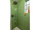 Close-up of the stylish shower with green tile at 1190 Briarcliff Ne Rd # 1, Atlanta, GA 30306