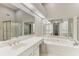 Bathroom featuring a jacuzzi tub, glass enclosed shower, and double sink vanity with mirrored wall at 2515 Oak Quarters, Smyrna, GA 30080