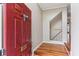 A bright red front door opens to reveal the entry foyer with gleaming hardwood floors and stairs at 2515 Oak Quarters, Smyrna, GA 30080