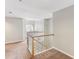 Bright upstairs hallway with wooden railing overlooks the entry, enhancing the home's openness at 2515 Oak Quarters, Smyrna, GA 30080