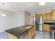 Open kitchen featuring an island, stainless steel appliances, and granite countertops at 2515 Oak Quarters, Smyrna, GA 30080