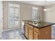 Stylish kitchen island with double sinks, granite counters, and views of the backyard through shuttered windows at 2515 Oak Quarters, Smyrna, GA 30080