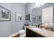 Powder room features a dark wood vanity, stone countertop, decorative mirror, and stylish accents at 4620 Westgate Dr, Cumming, GA 30040