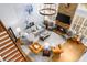 Aerial view of stylish living room with fireplace, hardwood floors, and comfortable seating arrangement at 4620 Westgate Dr, Cumming, GA 30040