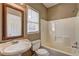 Well-lit bathroom featuring a pedestal sink, toilet, and tub with shower at 1027 Holland Rd, Dallas, GA 30157