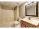 Full bathroom showcasing a tub-shower combination with a toilet, sink, and dark wood vanity at 1027 Holland Rd, Dallas, GA 30157
