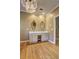Spacious bathroom featuring a dual sink vanity with decorative mirrors and stylish chandelier lighting at 1027 Holland Rd, Dallas, GA 30157