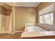 Relaxing bathroom featuring a soaking tub and separate shower, with natural light from a window at 1027 Holland Rd, Dallas, GA 30157