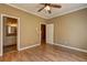Bedroom featuring hardwood floors, and doorway leading to the bathroom at 1027 Holland Rd, Dallas, GA 30157