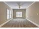 Spacious bedroom with neutral carpet, ceiling fan, and two windows providing plenty of natural light at 1027 Holland Rd, Dallas, GA 30157