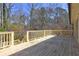 Spacious outdoor deck with wood planks and railings, overlooking trees and greenery at 1027 Holland Rd, Dallas, GA 30157
