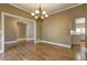 Dining area with hardwood floors and decorative chandelier adjacent to the kitchen at 1027 Holland Rd, Dallas, GA 30157