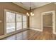 Dining room features hardwood floors, large windows overlooking deck and decorative chandelier at 1027 Holland Rd, Dallas, GA 30157