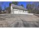 Home garage featuring a two-car garage and long driveway at 1027 Holland Rd, Dallas, GA 30157