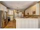 Kitchen with stainless appliances, granite countertops, kitchen island and white cabinets at 1027 Holland Rd, Dallas, GA 30157