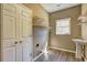 Laundry room with utility sink, open shelving and a window for natural light at 1027 Holland Rd, Dallas, GA 30157