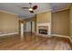 Cozy living room featuring hardwood floors, neutral-toned walls, and a stone fireplace at 1027 Holland Rd, Dallas, GA 30157