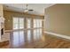 Expansive living room with stone fireplace, hardwood floors, and French doors leading to deck at 1027 Holland Rd, Dallas, GA 30157