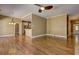 Spacious living room with hardwood floors, tan walls, white trim, and views into kitchen and entry at 1027 Holland Rd, Dallas, GA 30157