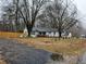 Inviting exterior view of a well-maintained home with a fenced yard and mature trees at 3250 Lee Dr, Buford, GA 30518
