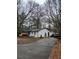 A well-maintained home featuring a long driveway and a neatly landscaped yard with mature trees at 3250 Lee Dr, Buford, GA 30518