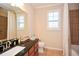 Bathroom with granite countertop, natural light, and tiled shower at 422 Windy Ridge Way, Canton, GA 30114