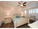 A serene main bedroom with a tray ceiling, plantation shutters, and elegant furnishings at 422 Windy Ridge Way, Canton, GA 30114