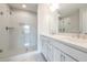 Bright bathroom featuring double vanity, white cabinets, and a glass-enclosed shower at 4822 Floydwood Ln, Mableton, GA 30126