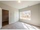 A bright bedroom with neutral carpet, walk in closet, and a sunny window at 4822 Floydwood Ln, Mableton, GA 30126