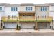 Exterior rear view of townhomes with garages and decks on the second level at 4822 Floydwood Ln, Mableton, GA 30126