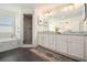 Elegant bathroom featuring a double vanity, marble countertops, soaking tub, and a separate glass-enclosed shower at 65 Vannoy Se St, Atlanta, GA 30317