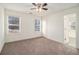 Spacious bedroom featuring neutral carpet, multiple windows with blinds, and a ceiling fan at 65 Vannoy Se St, Atlanta, GA 30317