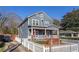 Two-story home with blue siding, a front porch, and a well-maintained front yard at 65 Vannoy Se St, Atlanta, GA 30317