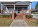 Inviting front porch with brick accents and a welcoming entrance, creating a warm and friendly atmosphere at 65 Vannoy Se St, Atlanta, GA 30317