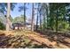 Spacious backyard surrounded by mature trees, offering a serene and private setting at 1618 Cheryl Leigh Dr, Riverdale, GA 30296