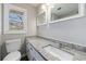 Updated bathroom features a speckled granite countertop and modern fixtures near a bright window at 1618 Cheryl Leigh Dr, Riverdale, GA 30296