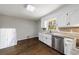 Kitchen with bright natural light, stone countertops and stainless steel dishwasher at 1618 Cheryl Leigh Dr, Riverdale, GA 30296