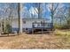 Backyard shows the rear exterior with a deck overlooking a lawn with mature trees at 1995 Tara Nw Ct, Kennesaw, GA 30144