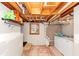 Unfinished basement features laundry area, concrete walls, wooden ceiling and vintage window at 1995 Tara Nw Ct, Kennesaw, GA 30144