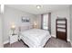 Neutral bedroom features a queen bed, carpet and a large window for natural light at 1995 Tara Nw Ct, Kennesaw, GA 30144