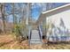 Gray painted deck with stairs leading to the lush backyard with mature trees at 1995 Tara Nw Ct, Kennesaw, GA 30144