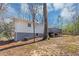 Exterior view of home, showing the yard, mature trees and a rear deck at 1995 Tara Nw Ct, Kennesaw, GA 30144