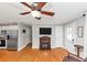 Bright living room open to kitchen with hardwood floors and modern ceiling fan at 1995 Tara Nw Ct, Kennesaw, GA 30144