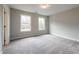 Carpeted bedroom with natural light from the two windows overlooking the backyard at 4826 Floydwood Ln, Mableton, GA 30126